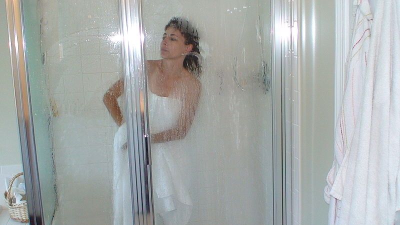 woman standing in framed shower enclosure
