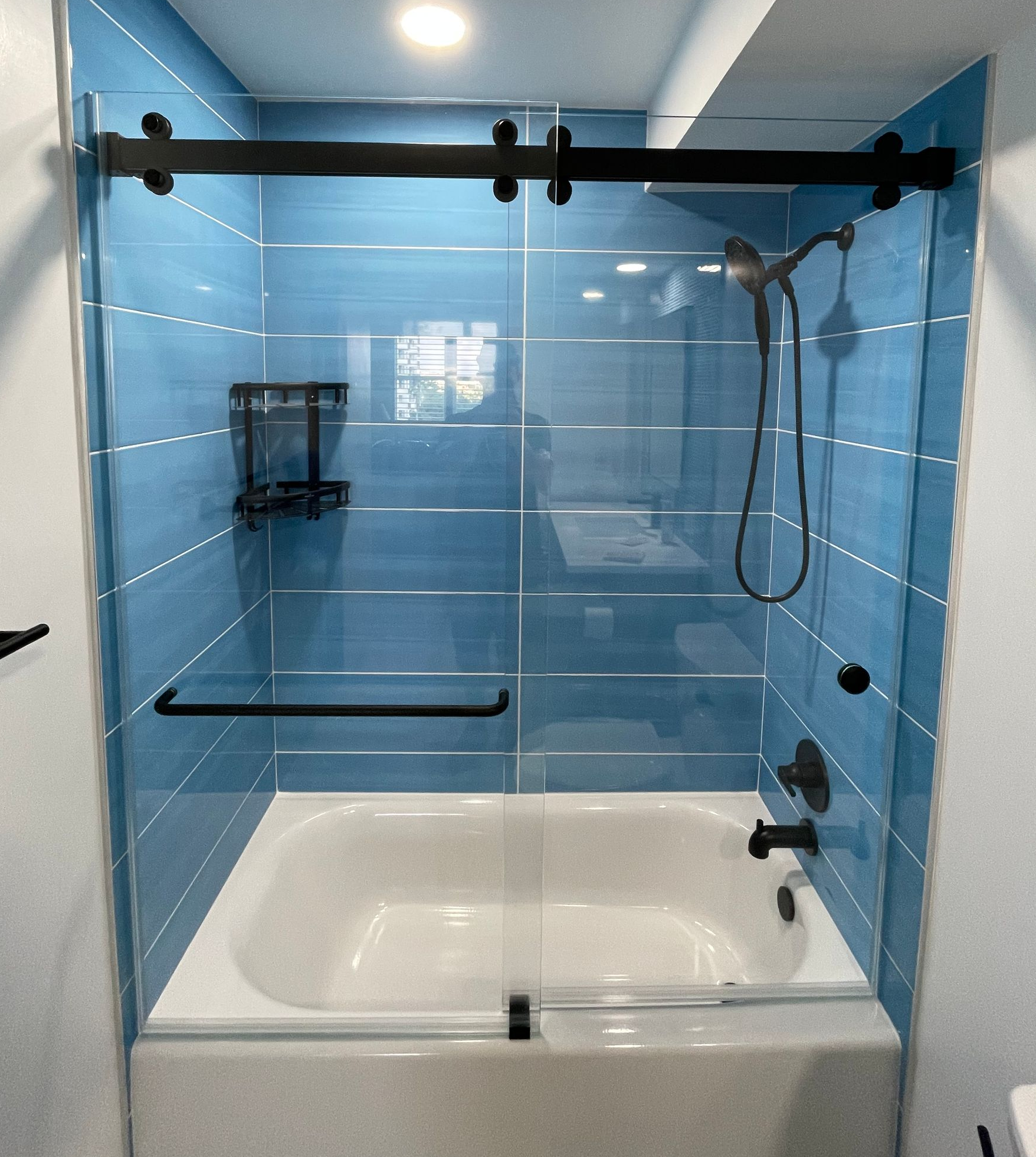 by-pass frameless shower door installed in bathroom