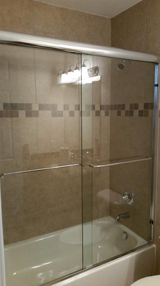 by-pass frameless shower door installed in bathroom
