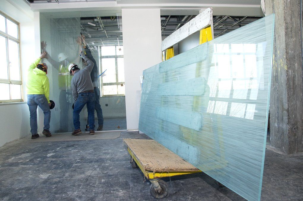 workers performing installation of a custom glass partition