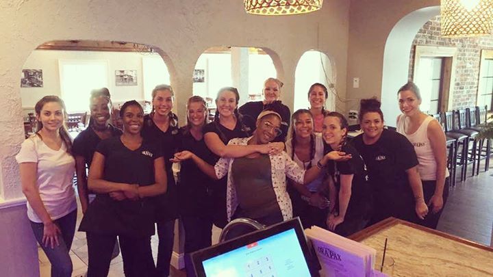 A group of women are posing for a picture in a restaurant.