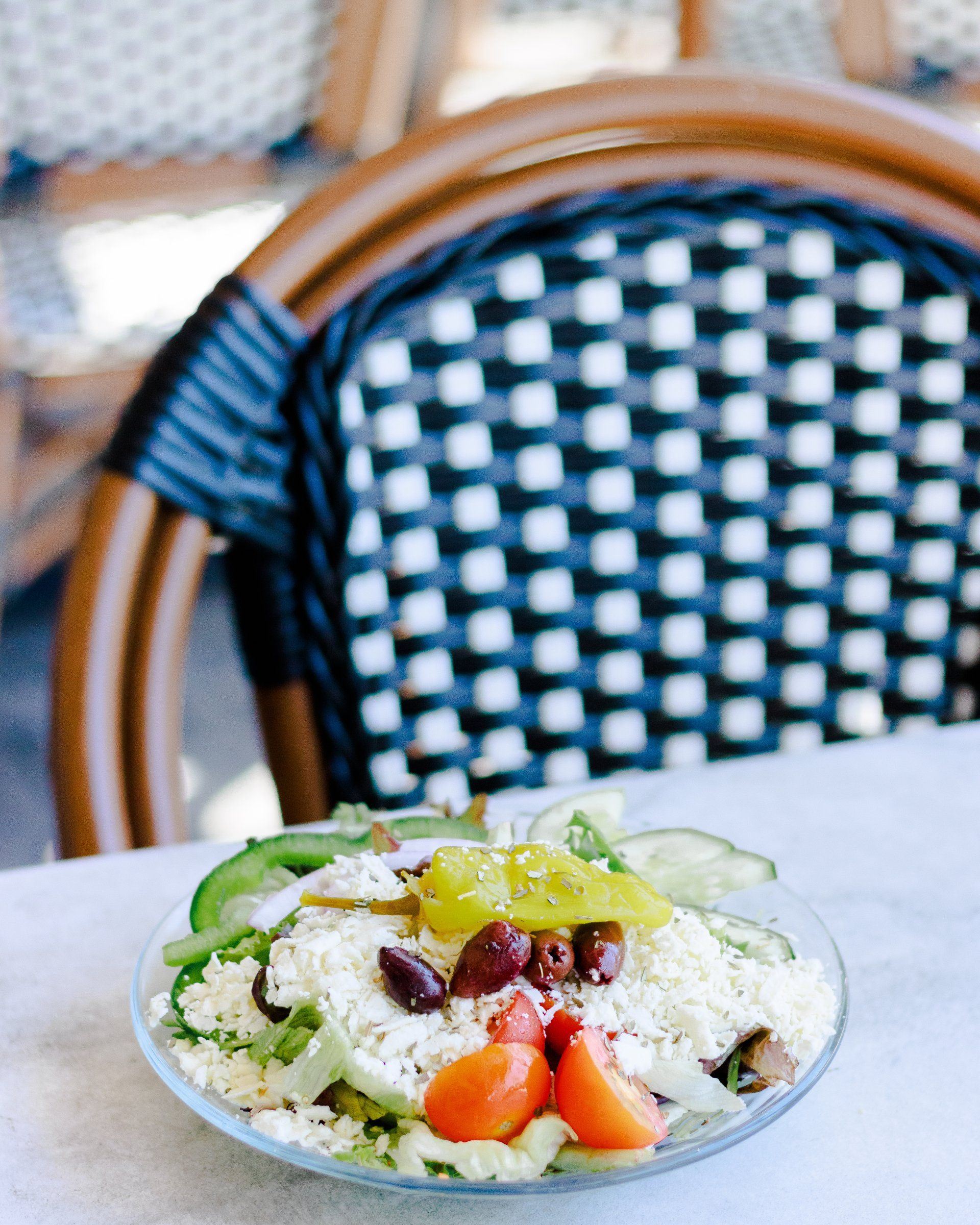 A plate of food is sitting on a table next to a chair.