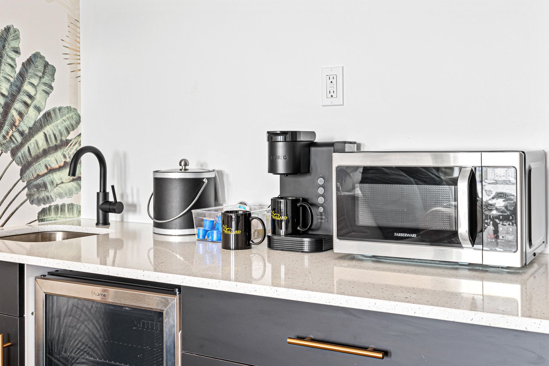 kitchen counter with microwave, coffee machine and sink
