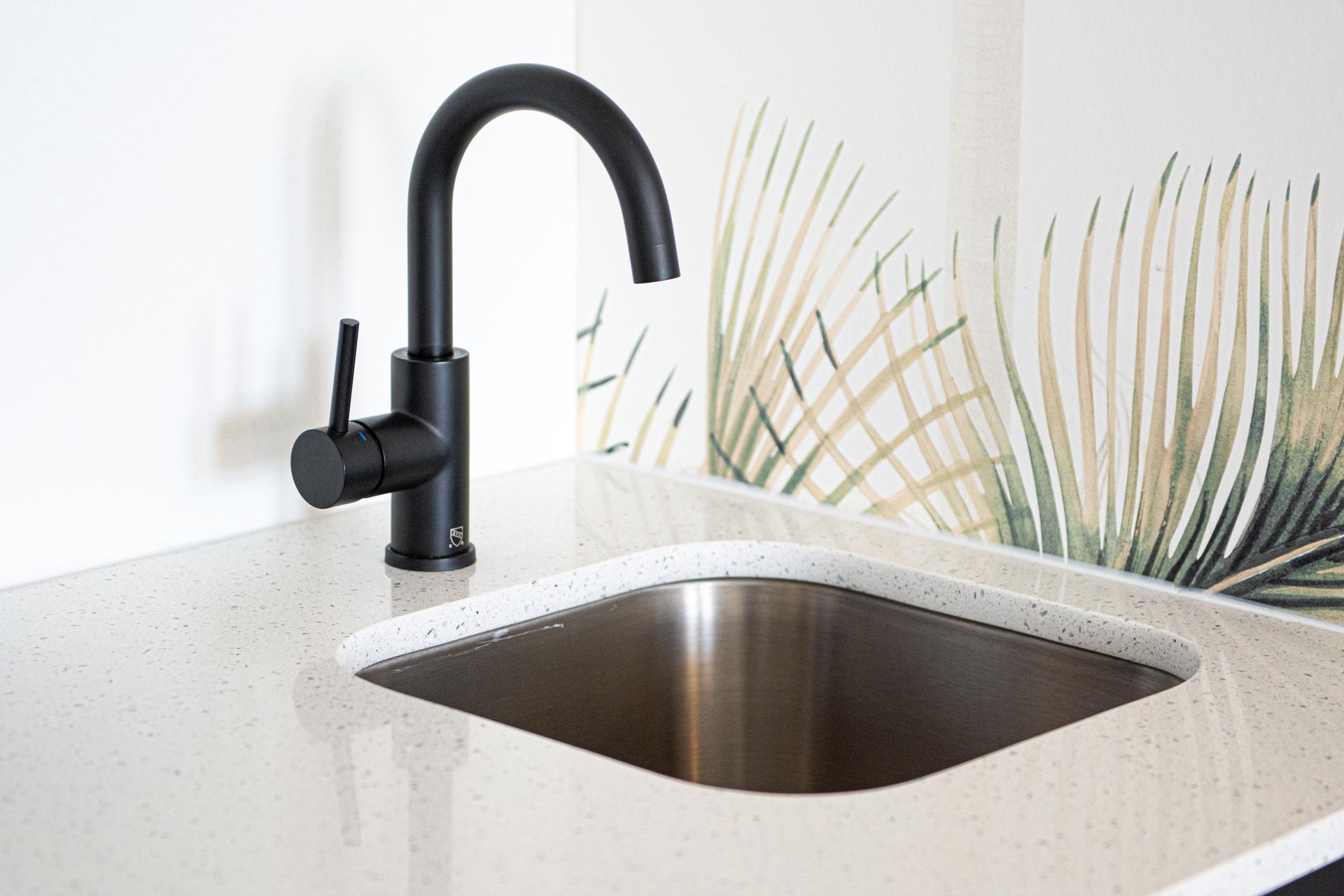 White granite sink with deep stainless steel sink and black sink handle