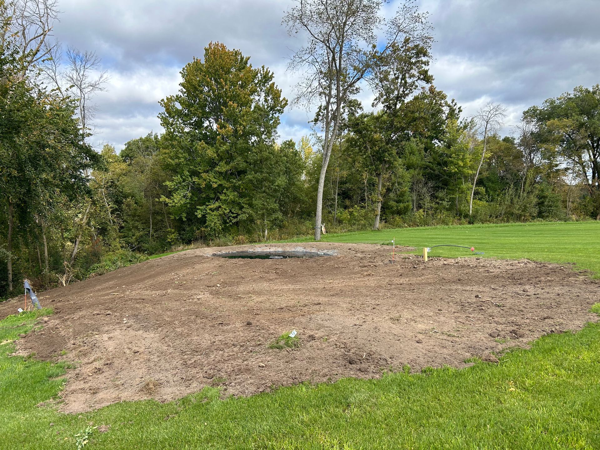 On the picture you can tell that the excavator just went through and cleared the land to build this pond.
