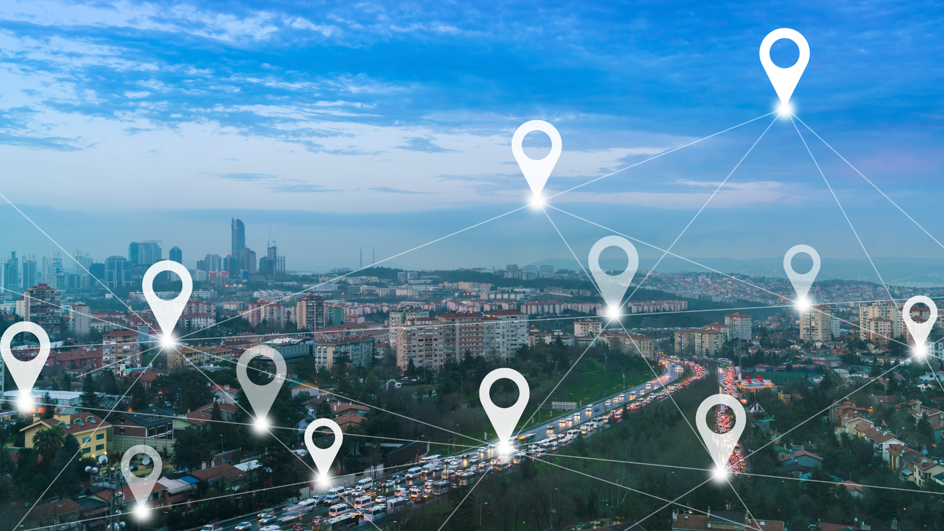 An aerial view of a city with a network of pins connected to each other.