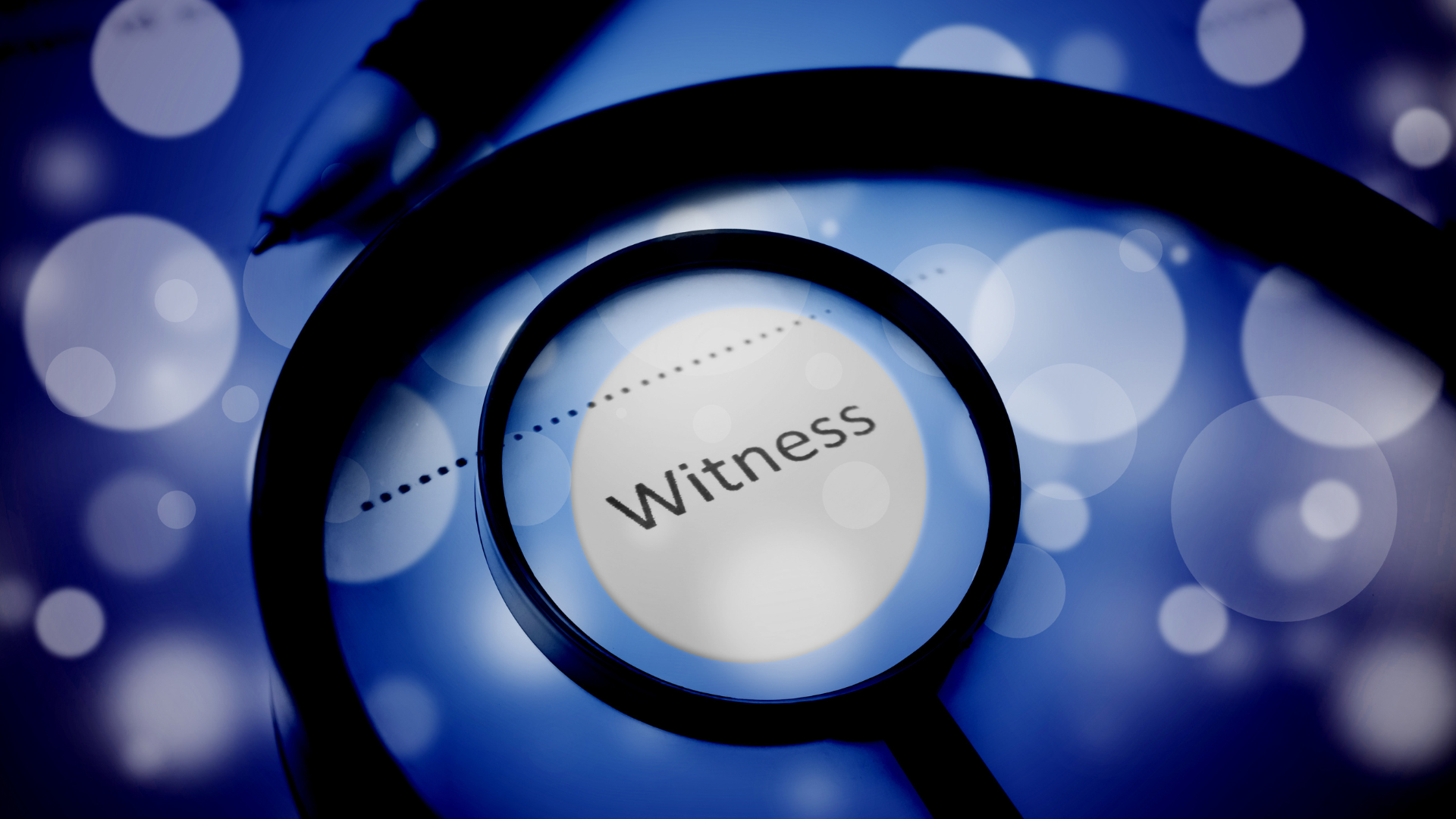 A magnifying glass with the word witness on it