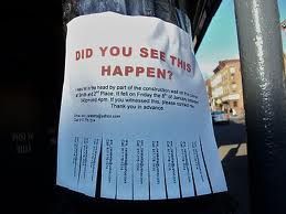A sign that says `` did you see this happen '' is taped to a pole.