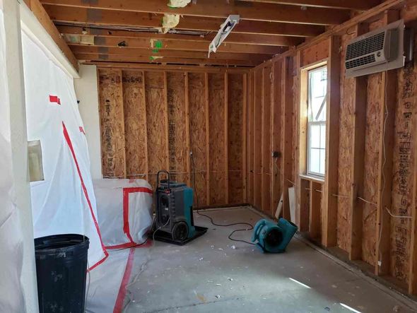 A room with a lot of wooden walls and a window.