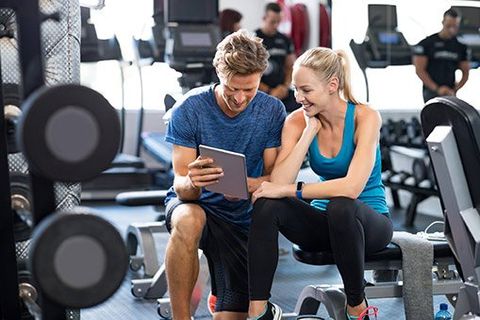 Personal Trainer — Trainer with Woman on Gym in Woburn, MA