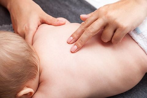 Chiropractic Care — Chiropractor Gently Massaging a Baby in Woburn, MA