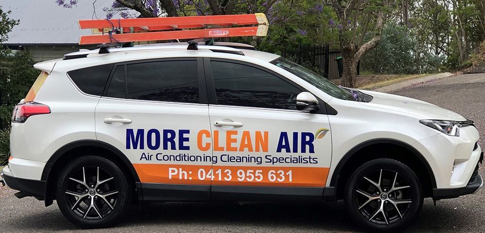 A White Car That Is Parked On The Side Of The Road — More Clean Air In Newcastle, NSW