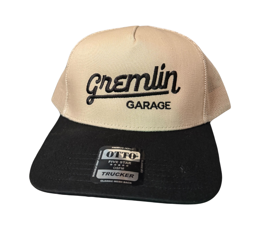 Tan and black hat with the Gremlin Garage logo