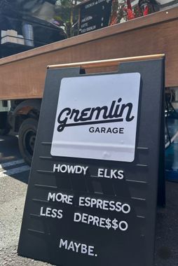 A black sign that says gremlin garage on it