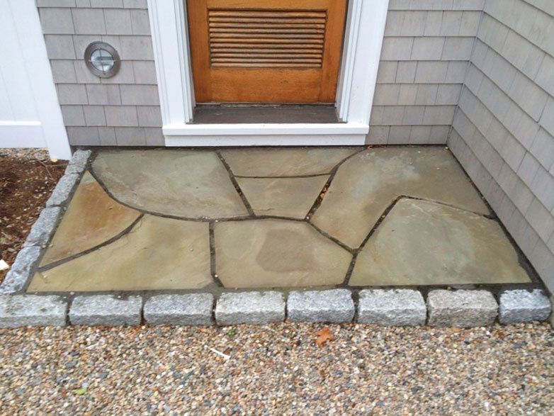 A stone walkway leading to the front door of a house