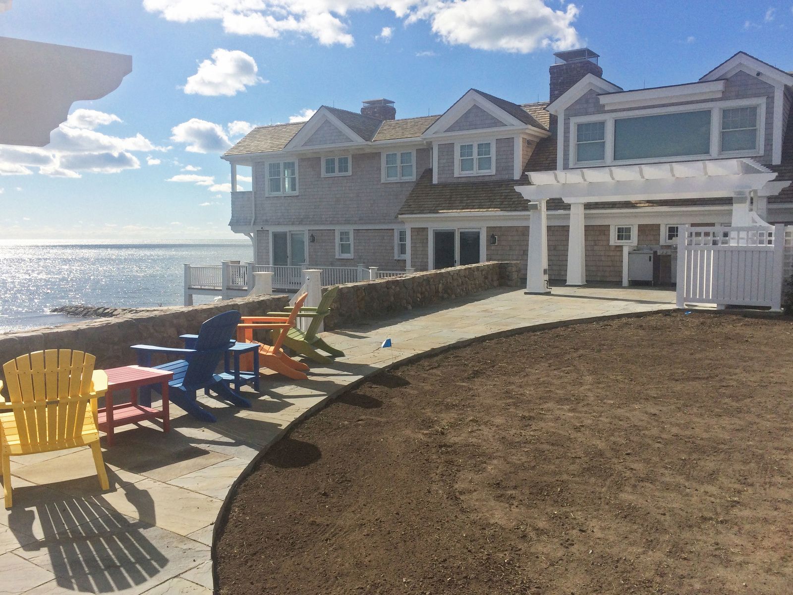 A house with a lot of chairs in front of it
