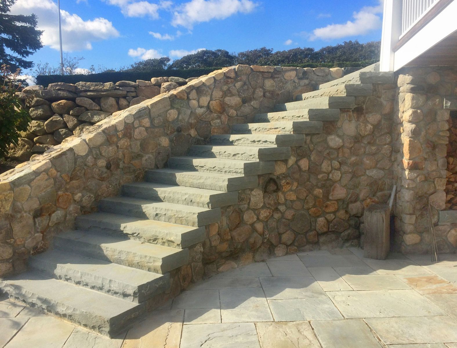 A set of stone stairs leading up to a stone wall