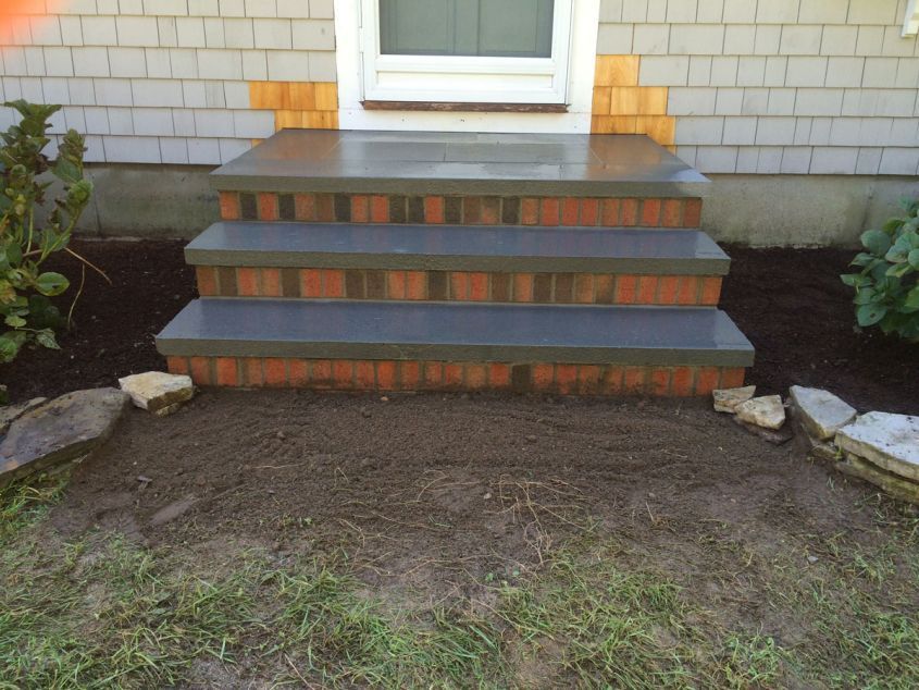 A set of brick steps leading up to a house