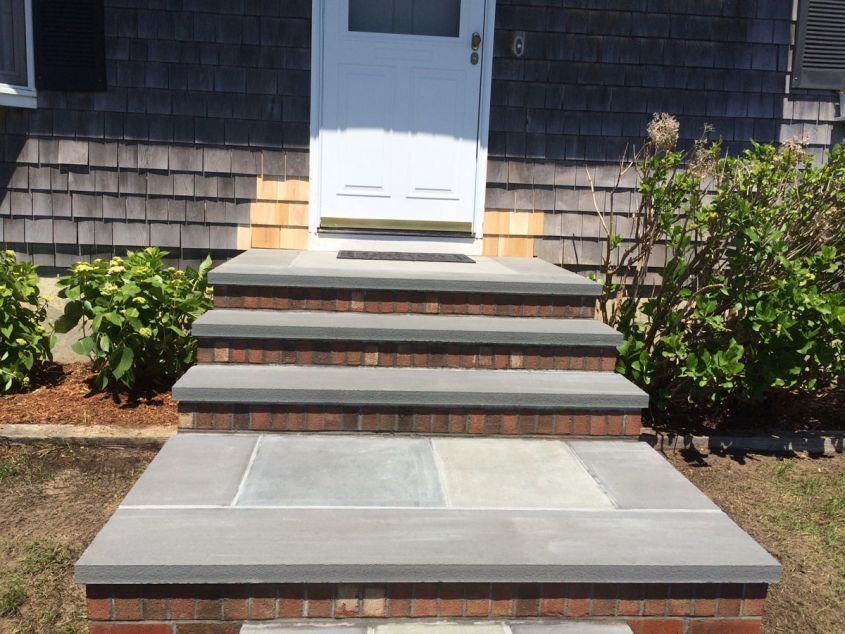A set of stairs leading up to the front door of a house