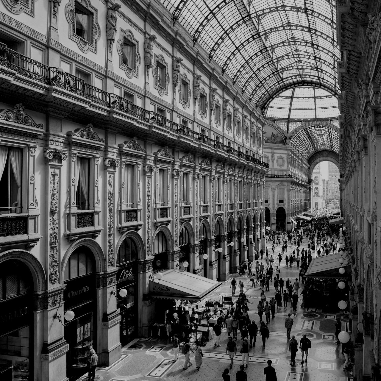 A black and white photo of people walking in a building