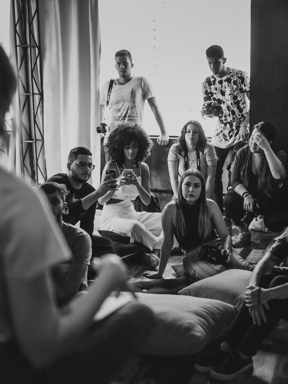 A black and white photo of a group of people sitting around a table