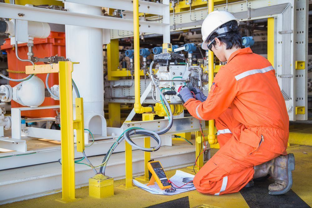 Man Conducts Testing On Electrical Installation — Barnes Electrical in Mackay, QLD