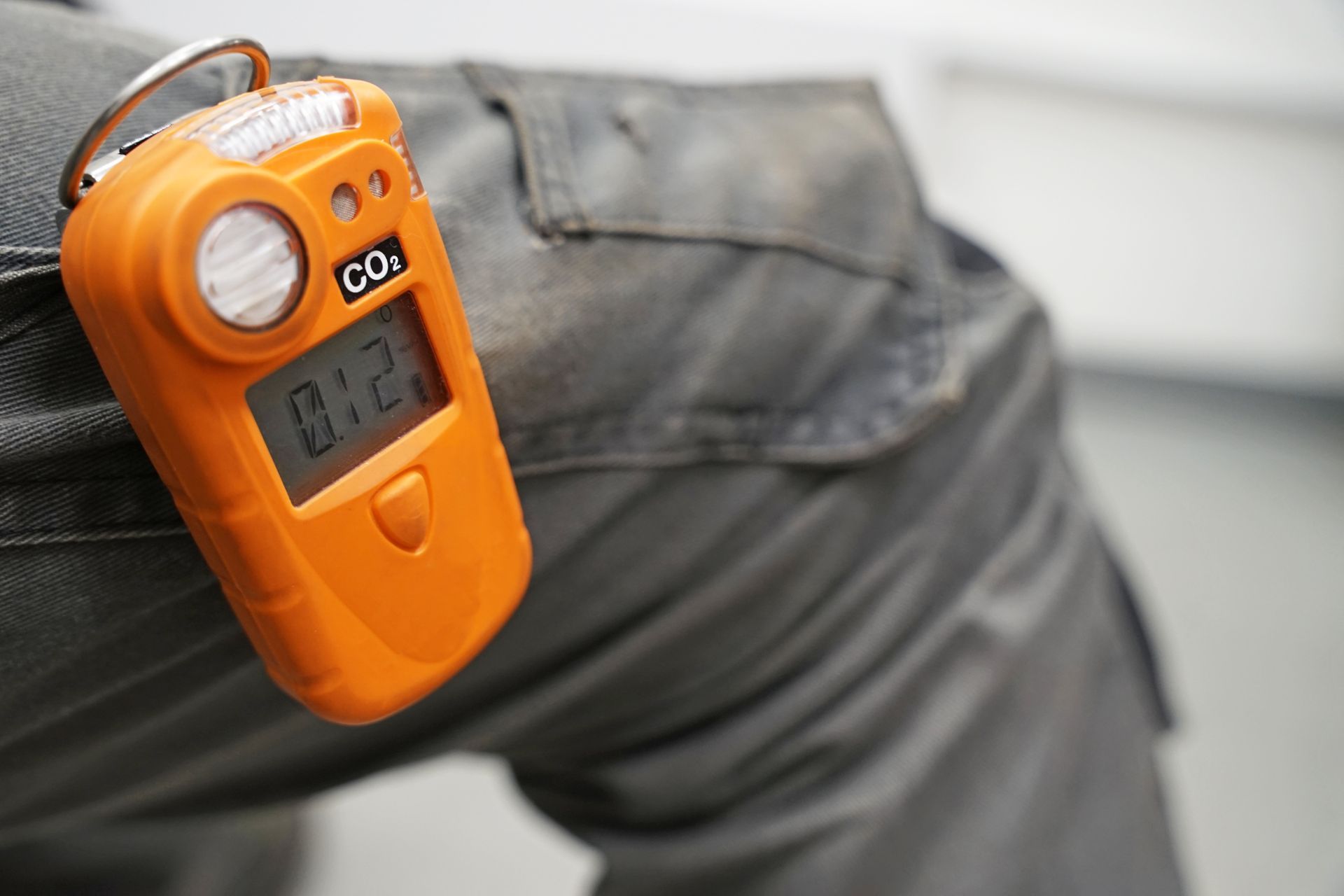 A CO₂ safety portable gas detector attached to a worker's trousers. A CO₂ safety portable gas detector attached to a worker's trousers.