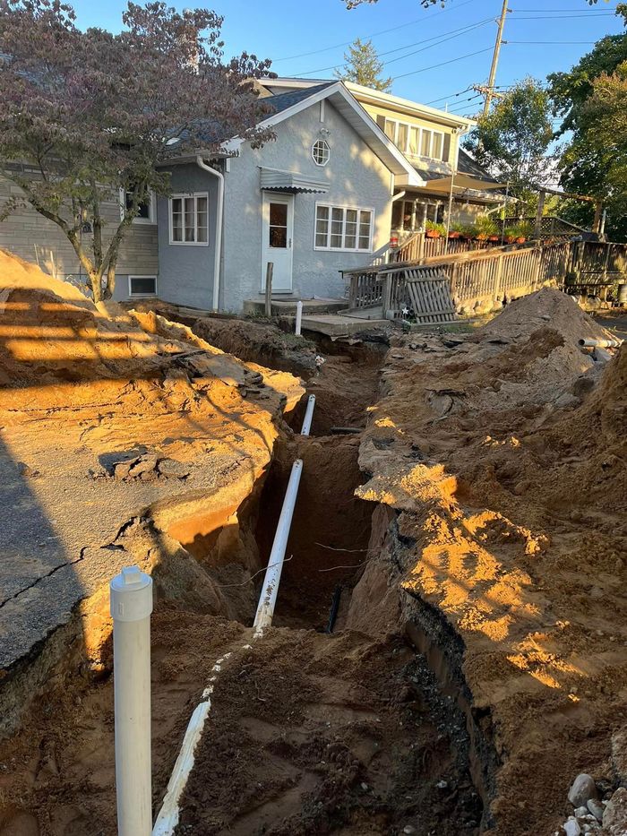 A house is being built next to a large pile of dirt.