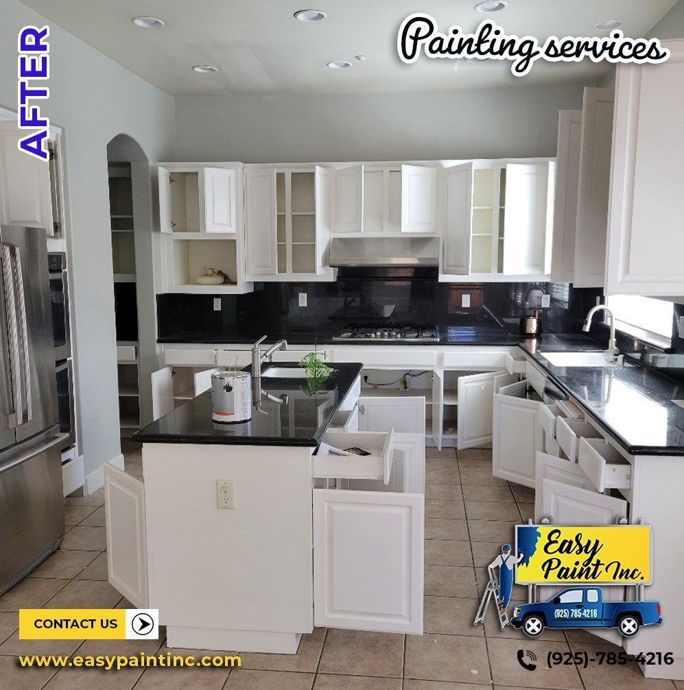 Kitchen with white cabinets, black countertops, and open drawers; after painting service by Easy Paint Inc.