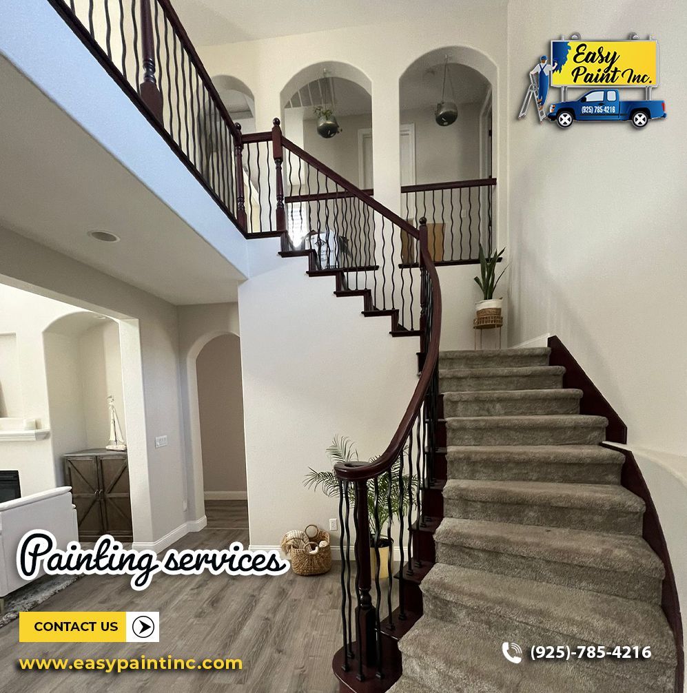 Staircase with brown banister and steps, leading to upper level with arched doorways. Easy Paint Inc. logo.