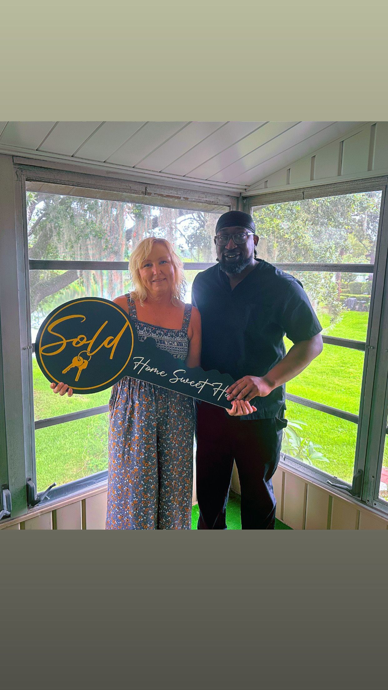 Back view of a person wearing a light blue blazer, dark braid, against a blue sky.
