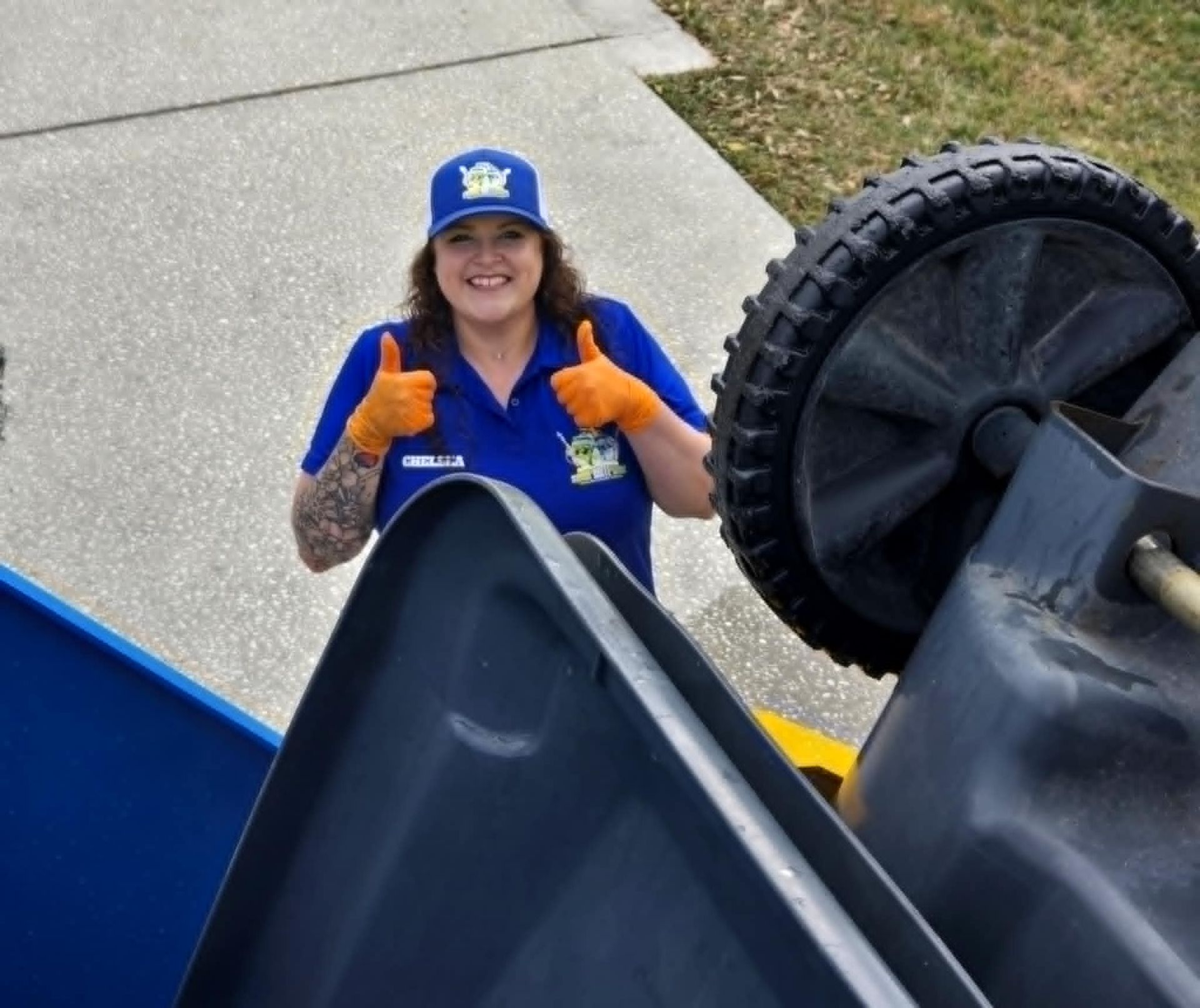 Two blue recycling bins are sitting on the side of the road.
