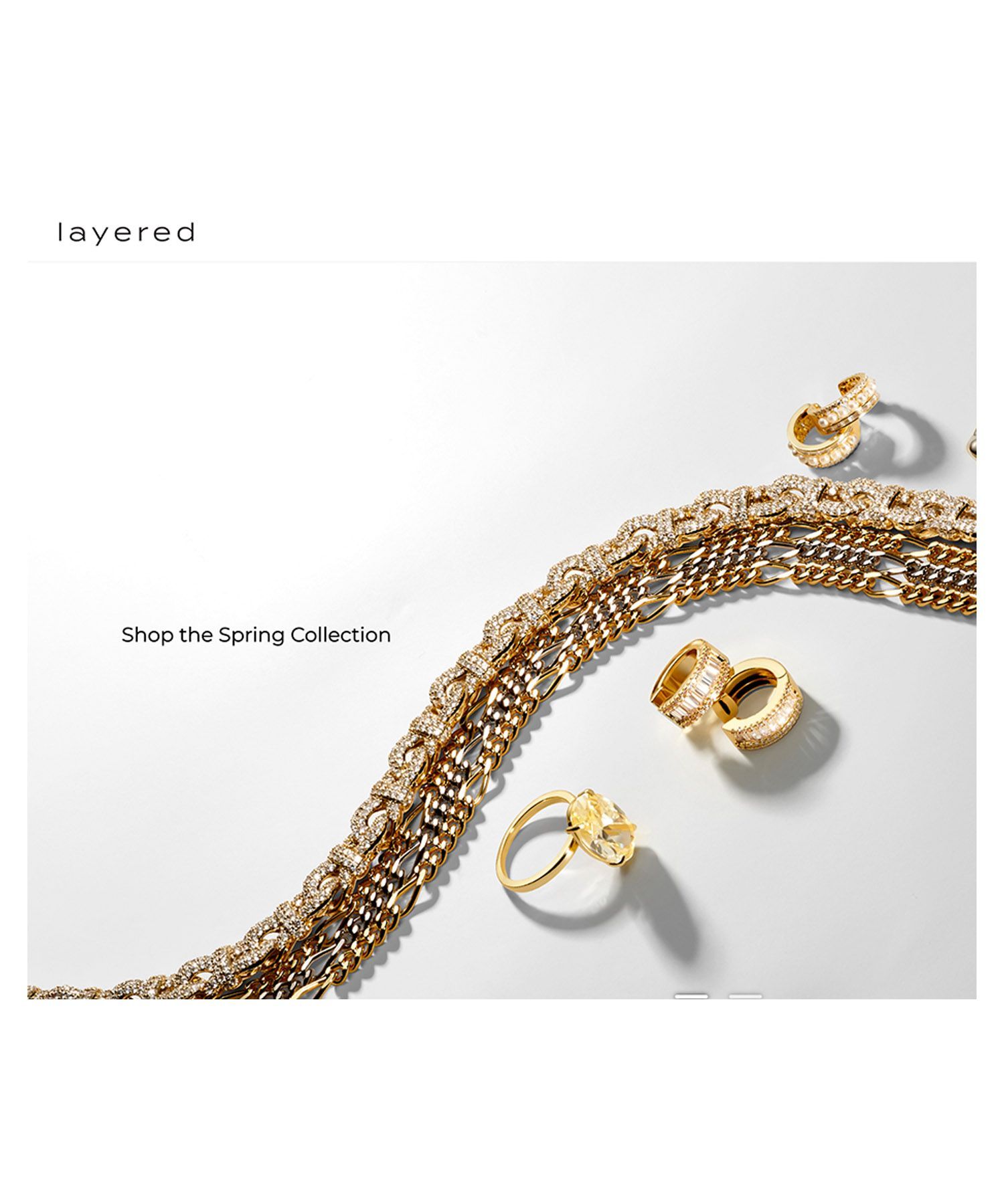 a necklace and rings are on a white surface .