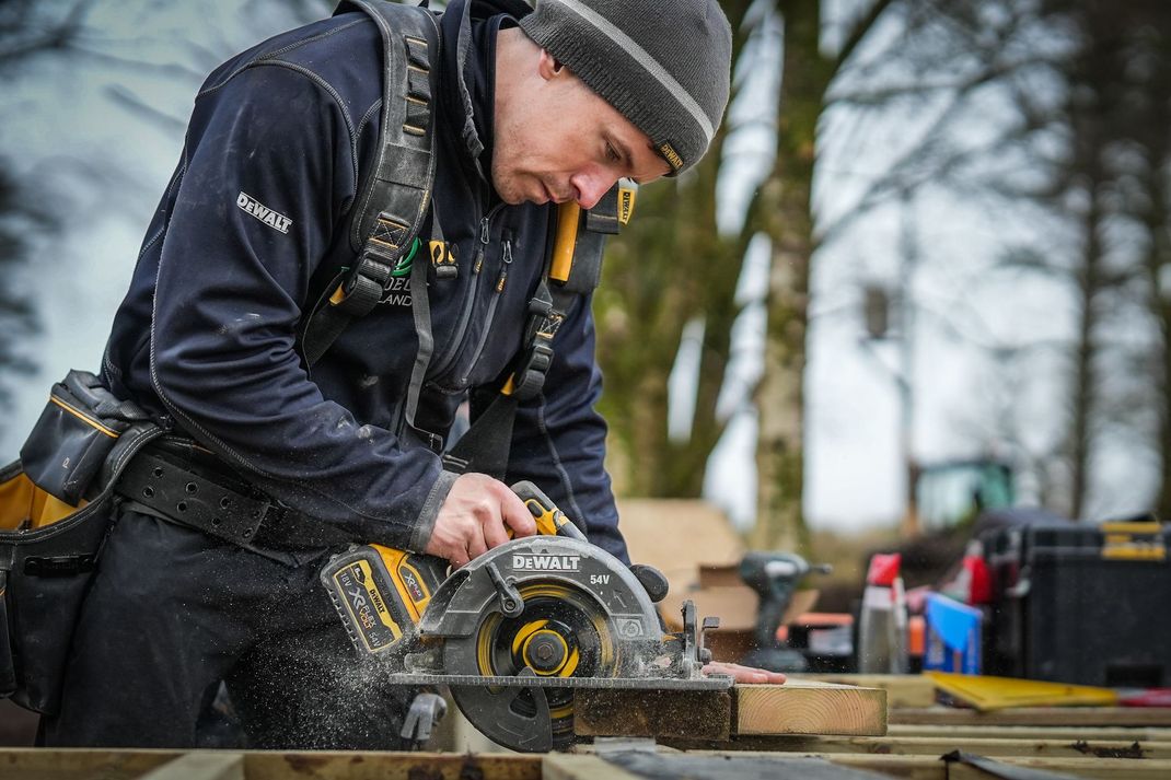 EcoDeck Scotland installation team of qualified joiners working on composite decking project, showing professional tools and safety equipment