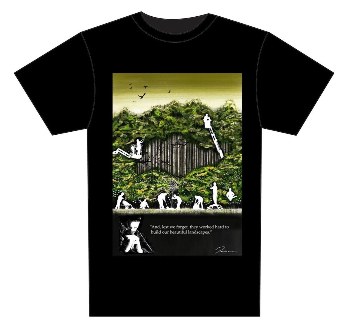 Black t-shirt with a forest scene graphic of figures building with tools, and a quote.