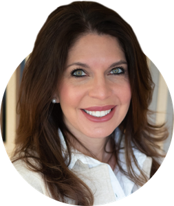 a woman with long brown hair is smiling and wearing a white shirt