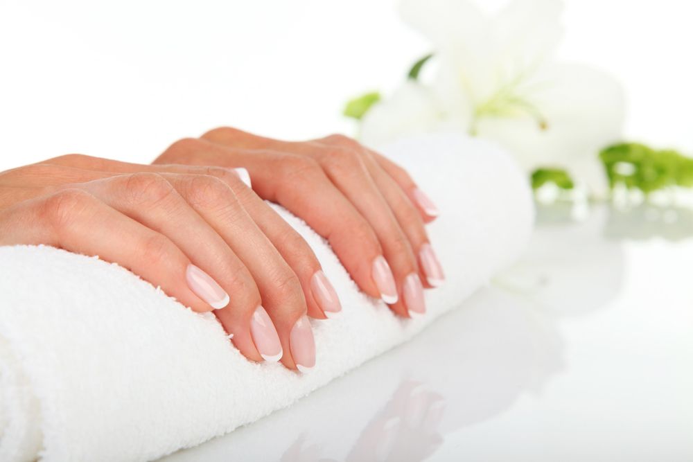 Woman Hands With Clean Nails Resting On A White Towel — Paradiso Skin & Beauty Studio in Byron Bay, NSW