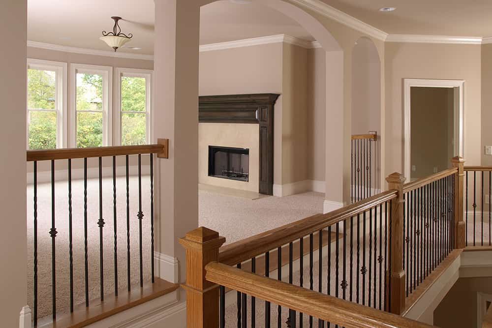 A staircase leading to a living room with a fireplace.