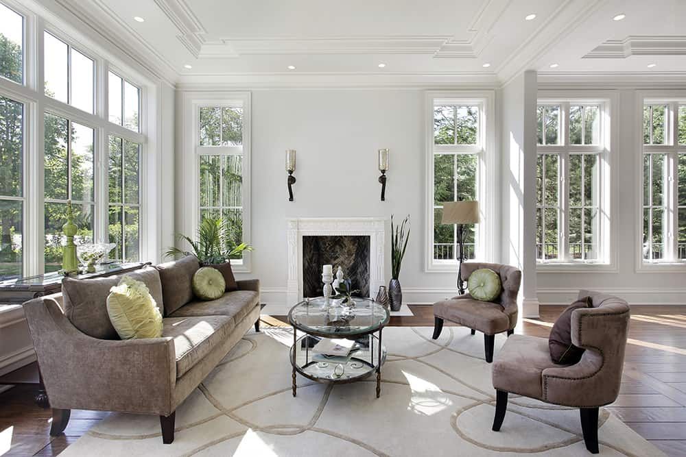 A living room with a fireplace and lots of windows