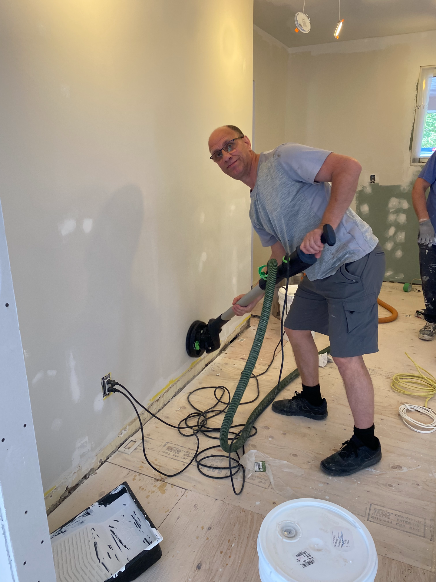 A man is using a vacuum cleaner in a room.
