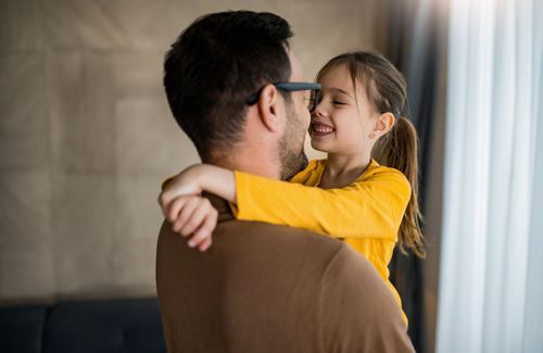 A Man Is Holding A Little Girl In His Arms - San Bernardino, CA - Bowen & Kennedy, P.C.