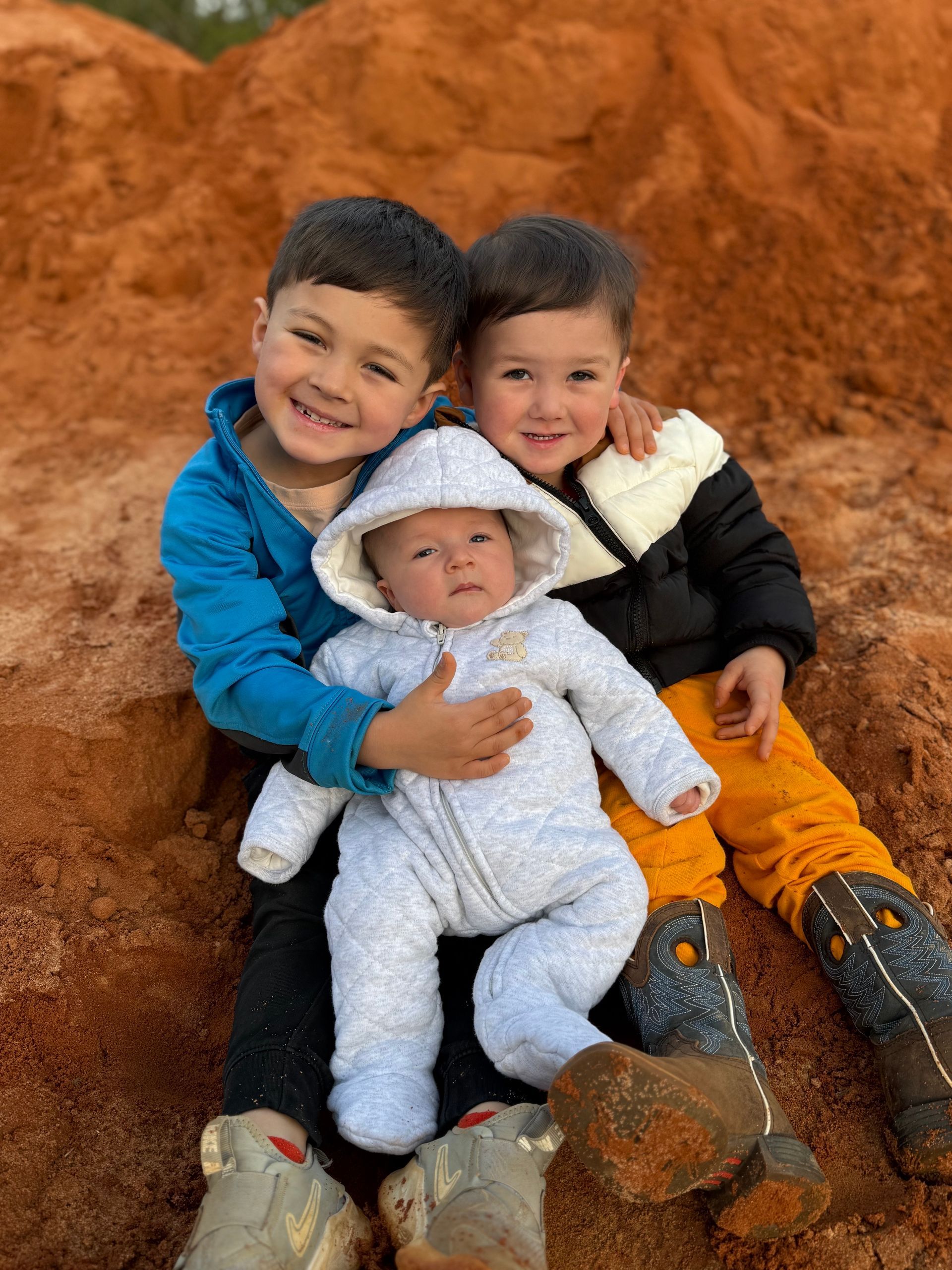 A boy wearing a brown shirt that says ' the mohawk ' on it