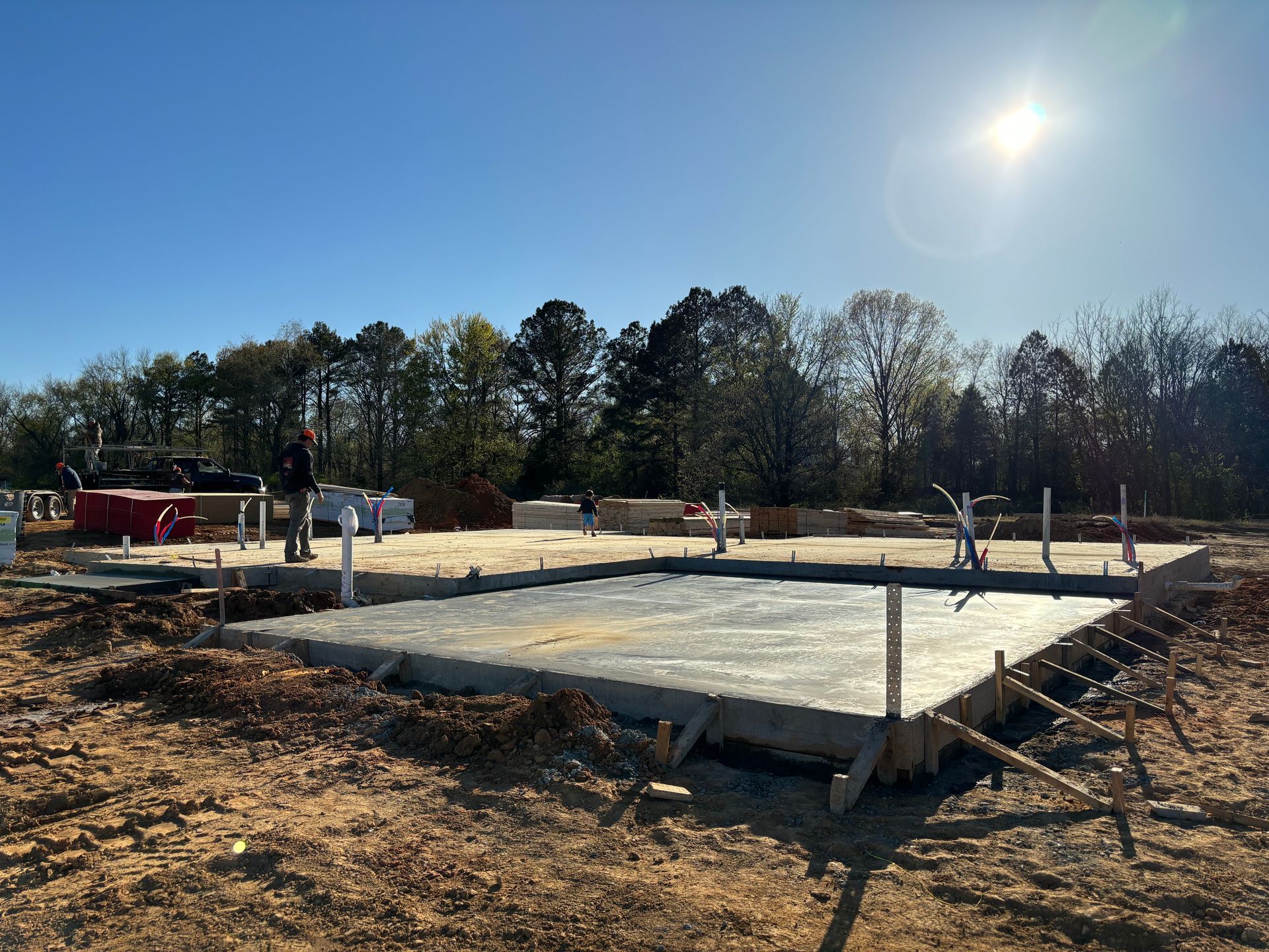 An excavator is loading dirt into a dump truck.