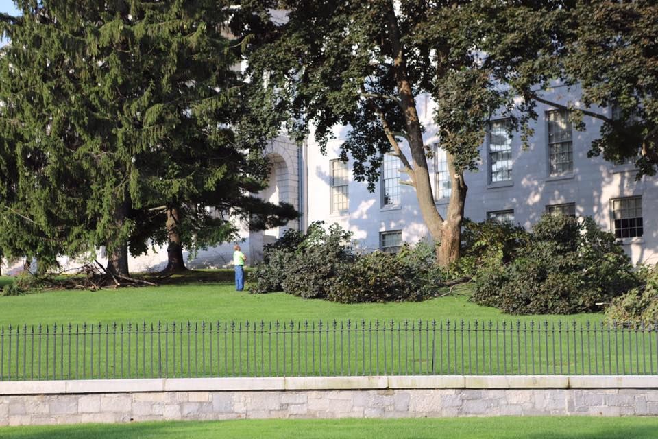 A white house with a fence in front of it