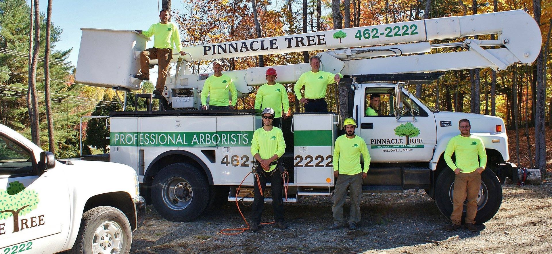 A group of pinnacle tree workers pose in front of a truck