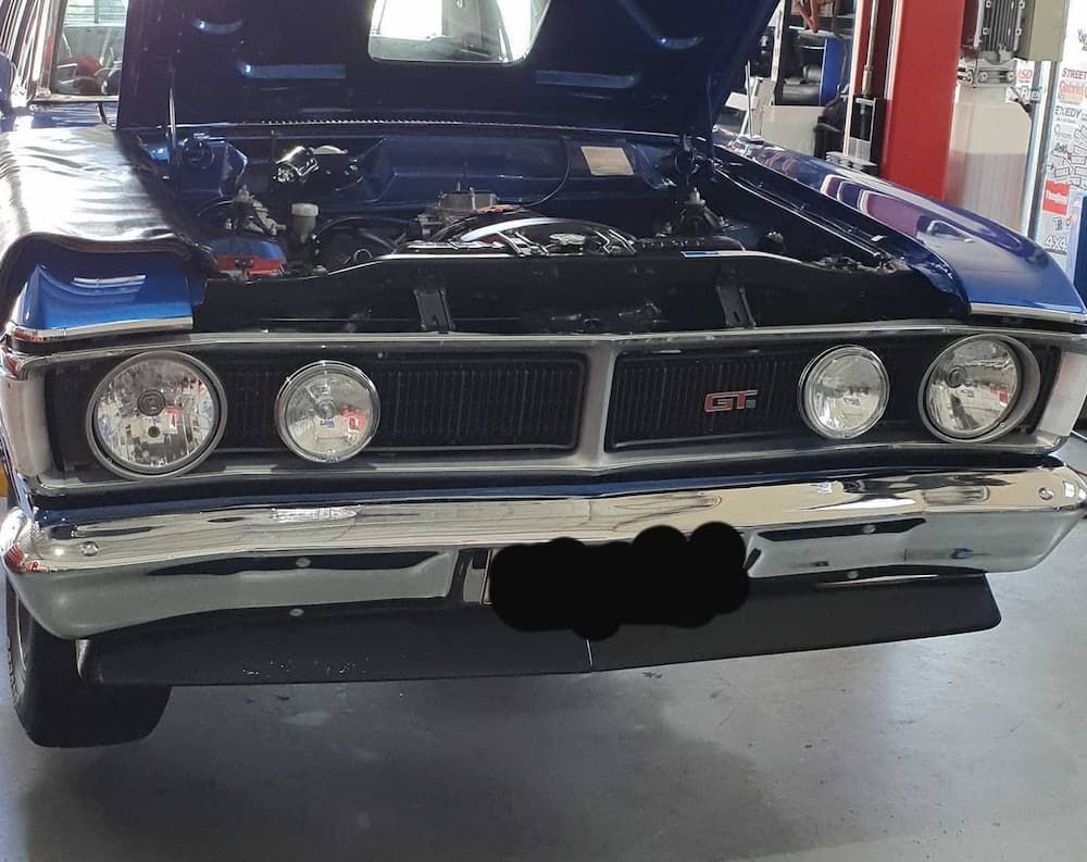 A Blue Car With Its Hood Up In A Garage — MTM Automotive in Bentley Park, QLD
