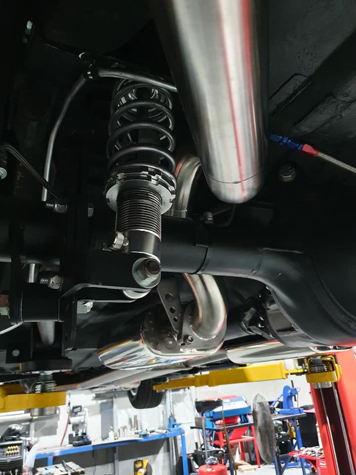 A Car Is Sitting On A Lift In A Garage — MTM Automotive in Bentley Park, QLD