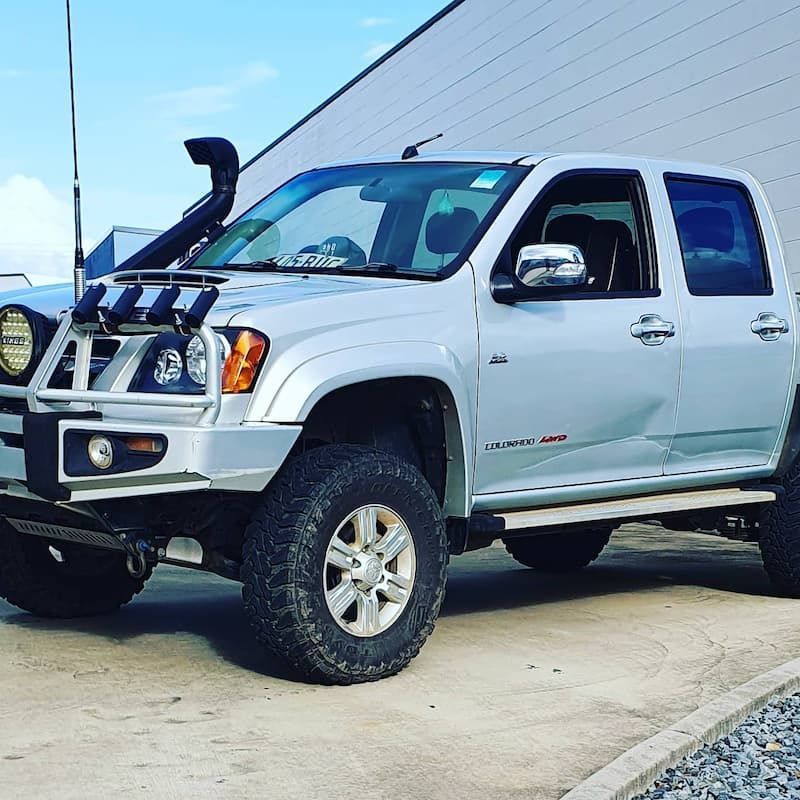 A Silver Truck Parked In Front Of A Building — MTM Automotive in Bentley Park, QLD
