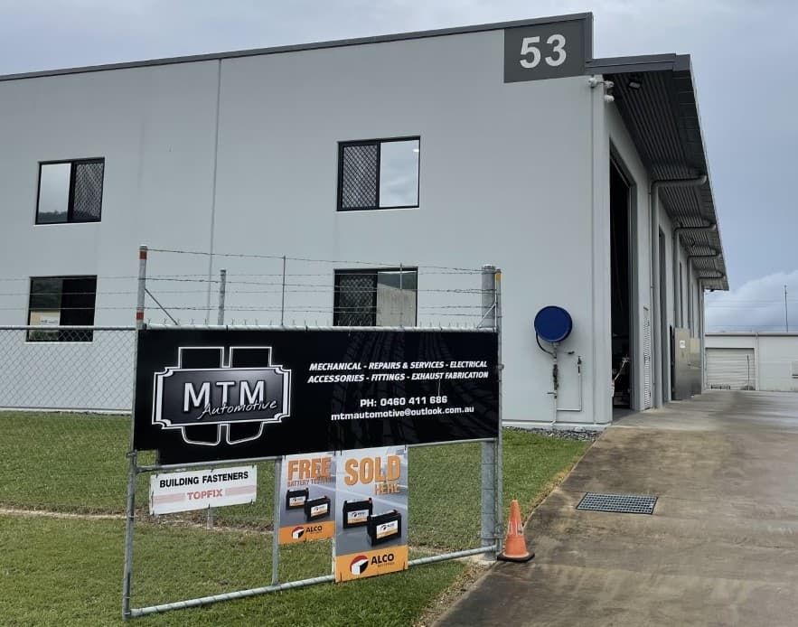 A Sign In Front Of A Building That Says MTM - Mechanic in Cairns, QLD
