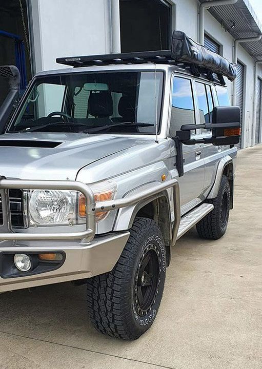 A Silver Truck With A Tent On Top Of It Is Parked In Front Of A Building — MTM Automotive in Bentley Park, QLD
